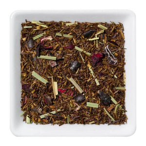 Biologische rooibos thee met passievrucht in een witte schaal, met kruiden en natuurlijke ingrediënten.
